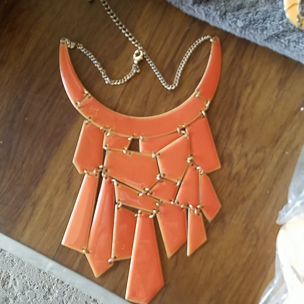 Orange metal necklace.